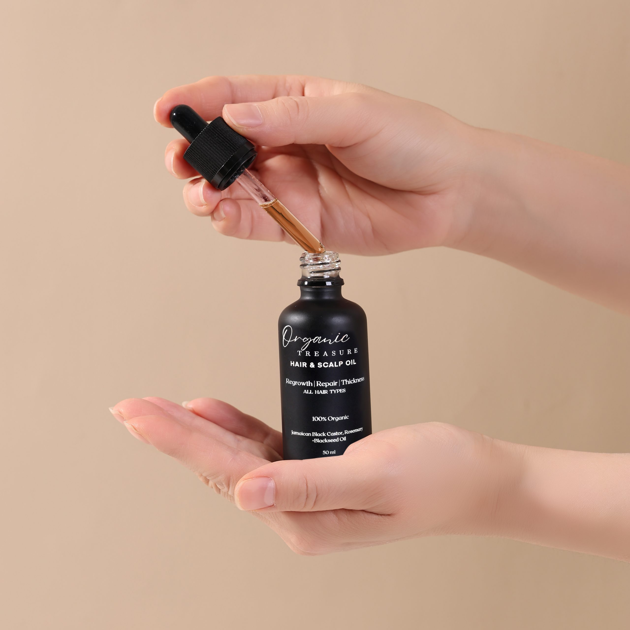 Applying Organic Hair Growth Oil to scalp and hair for growth, shine, and nourishment